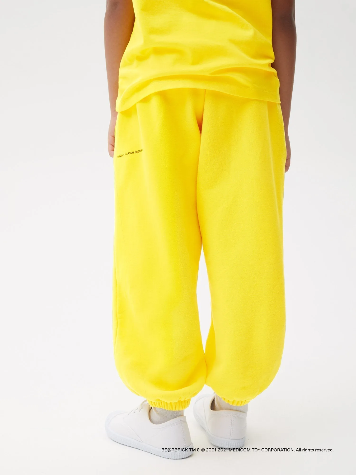 Pangaia x Haroshi BE@RBRICK™ Kids Track Pants—saffron yellow